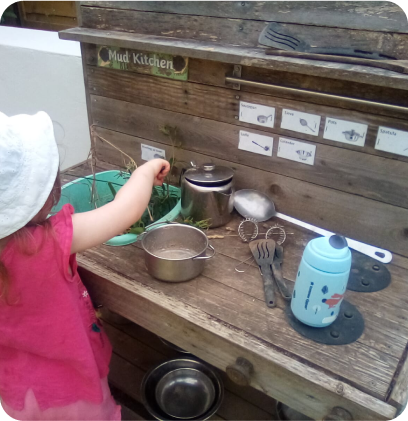A child using the outdoor kitchen